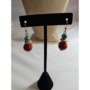 Gold tone earrings .